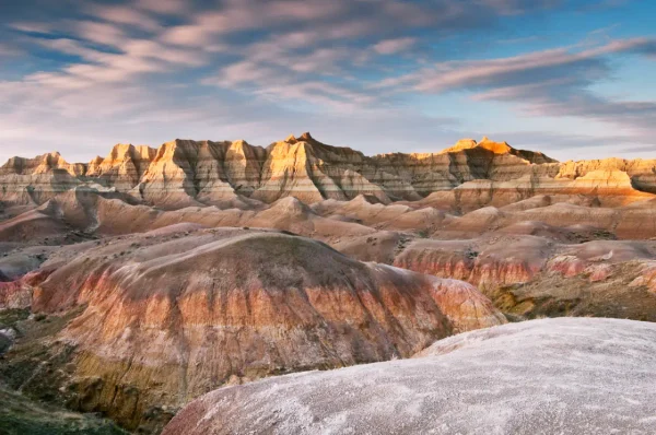 Colorful layered rock formations at Badlands National Park at sunset in South Dakota.